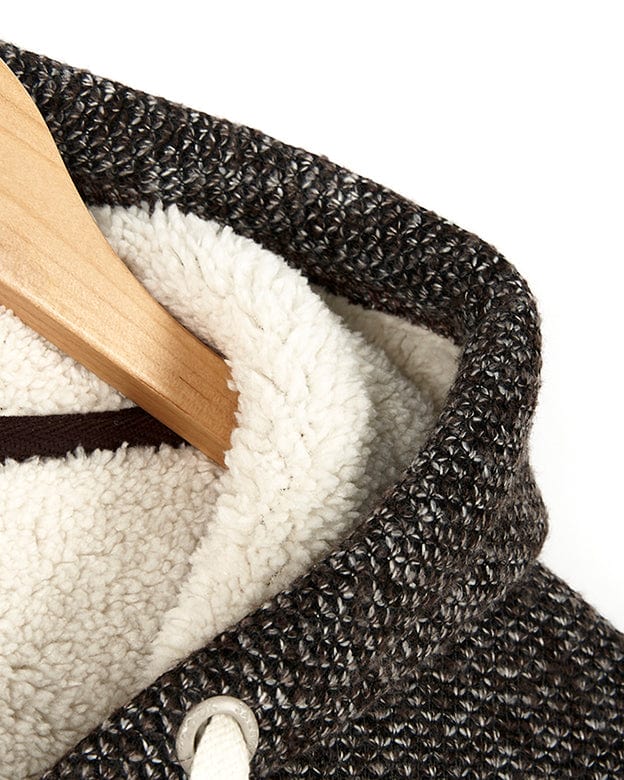 The Sofie - Womens Borg Lined Zip Hoodie - Brown, a black and white textured knit sweatshirt, elegantly adorns a wooden hanger. (Brand: Saltrock)