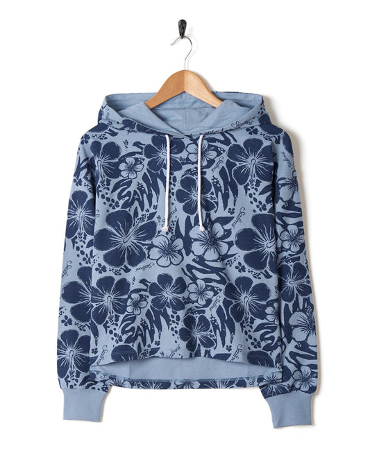 A women's Saltrock Soifra Hibiscus - Womens Pop Hood - Blue hoodie hanging on a hanger.