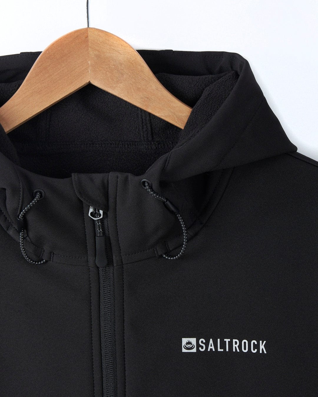 A Saltrock Solar - Womens Softshell Jacket - Black - SS24 with a white logo on it.