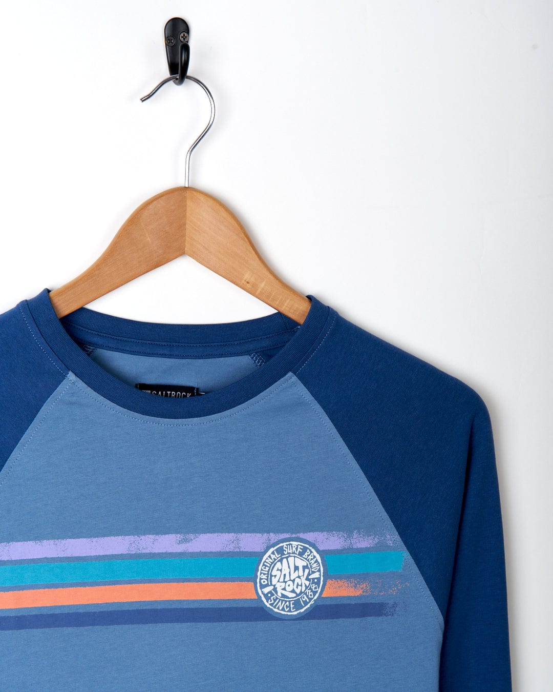 A cotton raglan t-shirt with an orange and blue stripe from Saltrock.