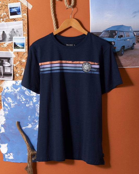 A Spray Stripe - Mens Short Sleeve T-Shirt - Blue hanging on an orange wall.
