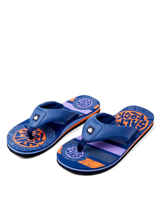 A pair of blue and orange Saltrock flip flops with stripe soles and logo branding, positioned against a white background.