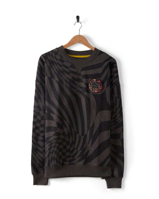 The SR Warp Men's Oversized Sweat in grey by Saltrock, displayed on a wooden hanger, features a black and gray geometric print with a circular chest patch and is crafted from recycled materials.