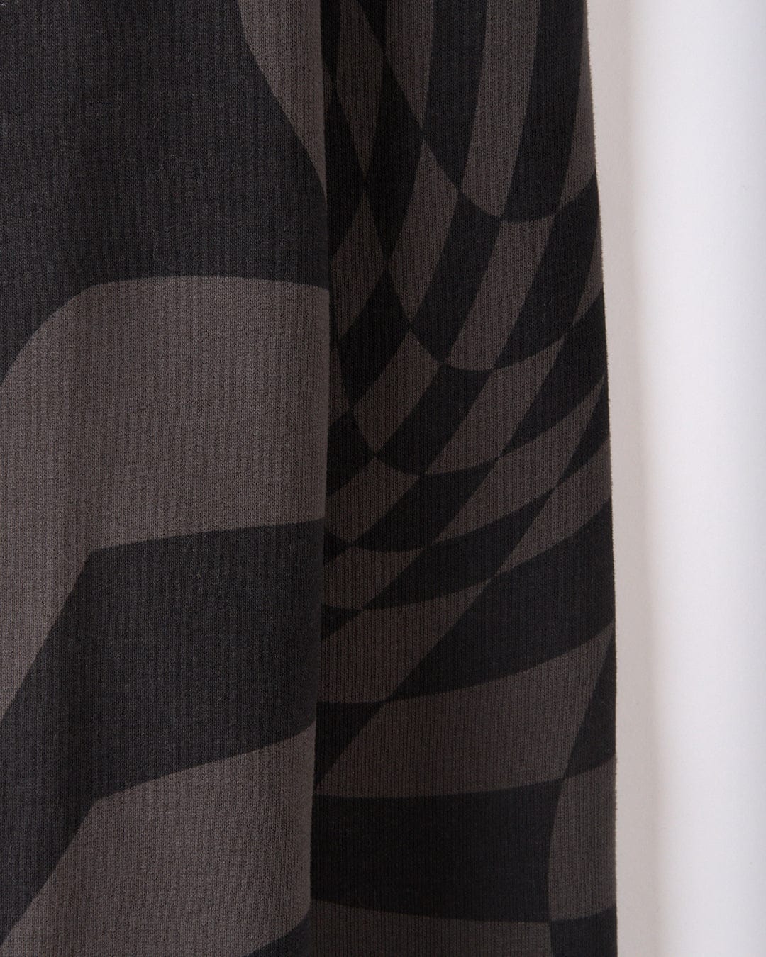 The SR Warp Men's Oversized Sweat in gray by Saltrock features black and gray fabric with a geometric, wavy pattern that creates a 3D optical illusion effect.