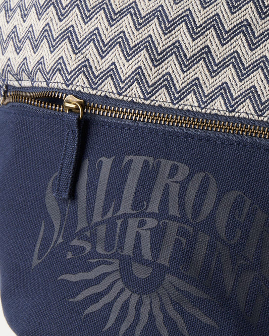 Close-up of a Saltrock Calbis Shoulder Bag - Blue with a zigzag pattern and surfing branding, featuring a partially opened gold zipper.