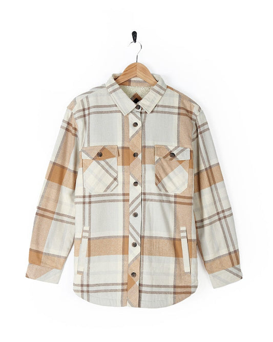 A white and tan plaid Saltrock Stella - Womens Checked Borg Lined Shacket - Cream shirt with buttoned cuffs hanging on a hanger.