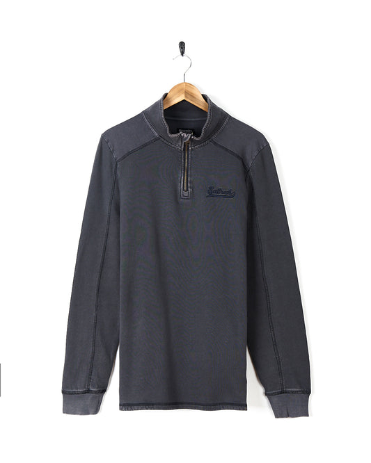 A Stellan - Mens 1/4 Neck Sweat - Grey Acid Wash sweatshirt hanging on a hanger. 
Brand: Saltrock