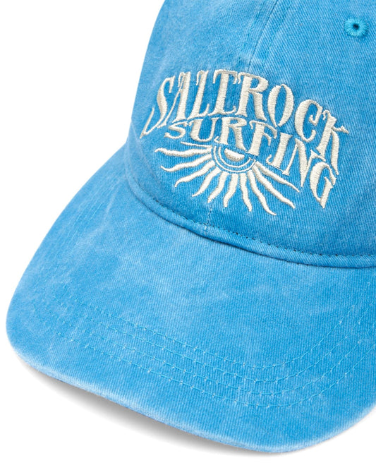 Sunburst Cap - Blue cotton baseball cap with "Saltrock surfing" and sunburst graphic embroidery.