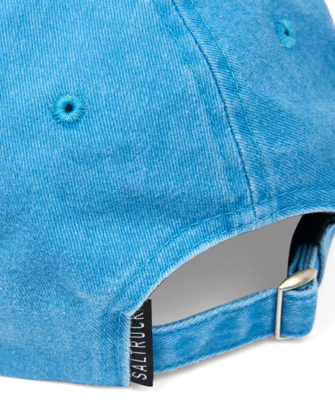 Close-up of a Saltrock Sunburst Cap - Blue with sunburst graphic embroidery and an adjustable strap.
