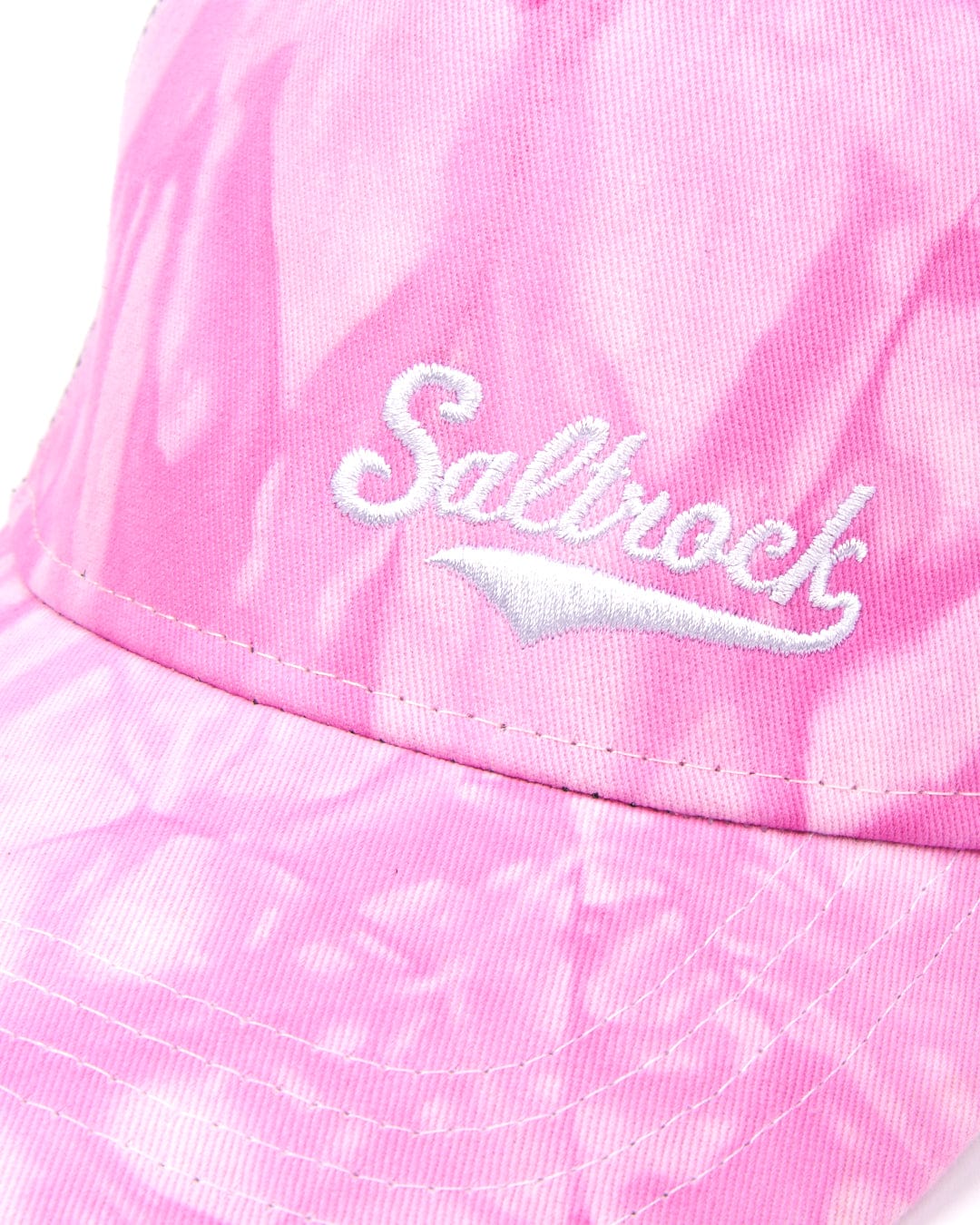 Close-up of a Swifty Trucker Cap - Pink branded Saltrock with tie-dye print.