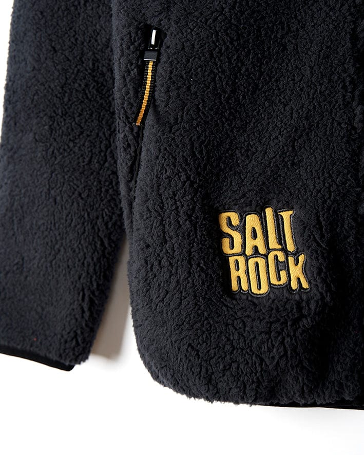 A warm Tagged - Kids Sherpa Fleece - Black jacket with the word Saltrock on it.