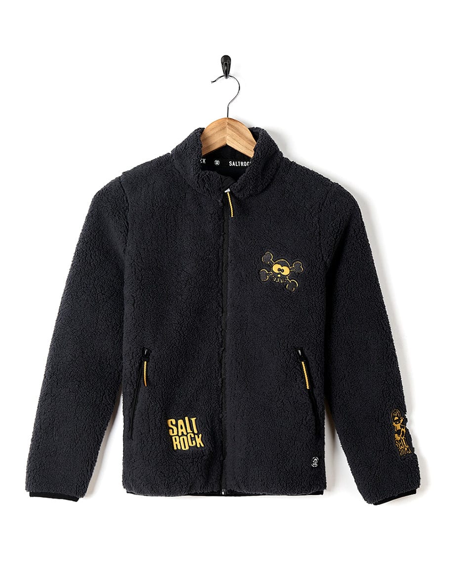 A Tagged - Kids Sherpa Fleece - Black jacket with a skull and crossbones on it. (Sold by Saltrock)