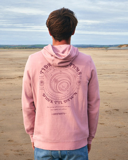 The back of a man standing on the beach wearing a Saltrock Tidal Rhythms - Mens Pop Hoodie - Pink.
