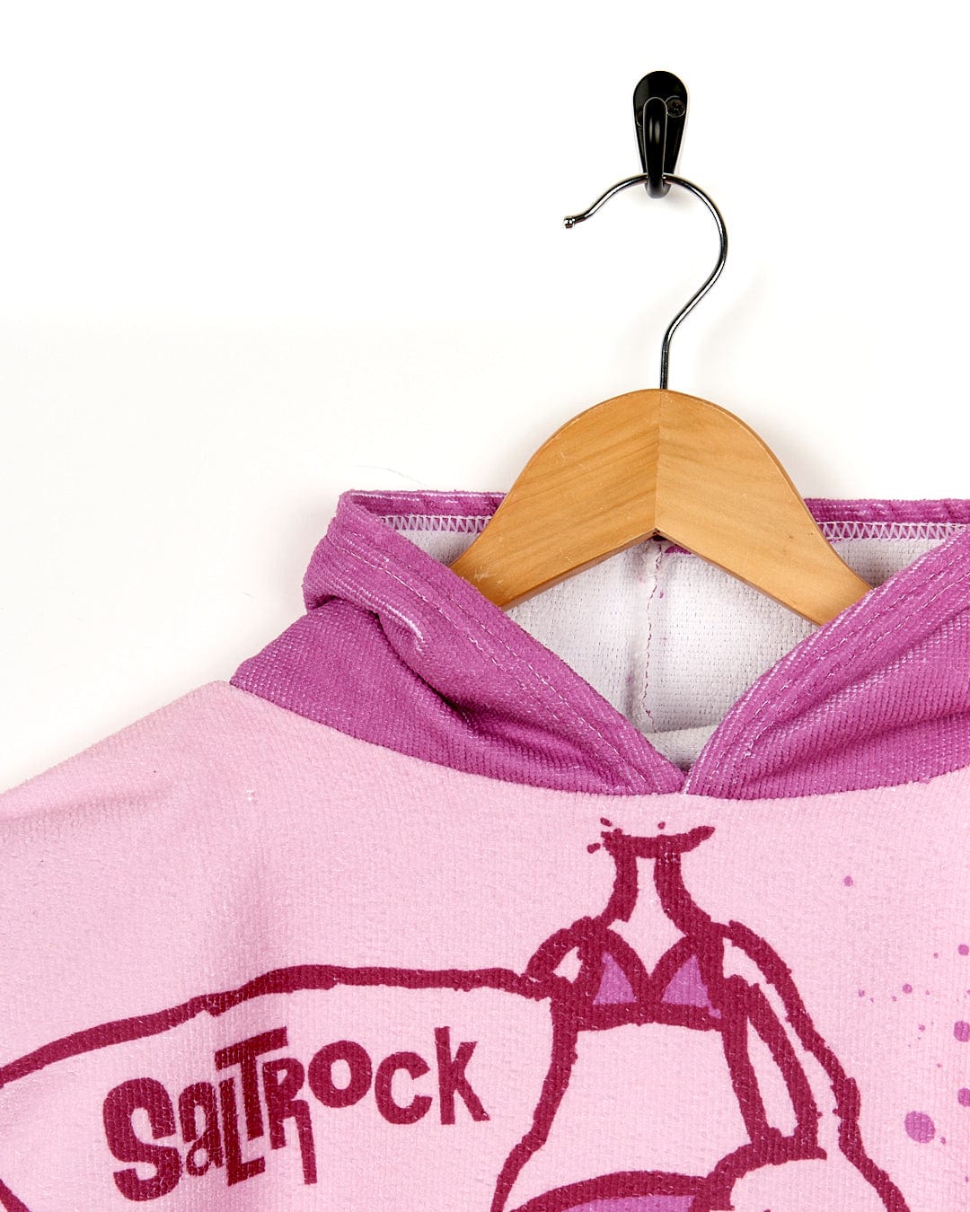 A Saltrock pink hoodie with an image of a girl riding a surfboard.
