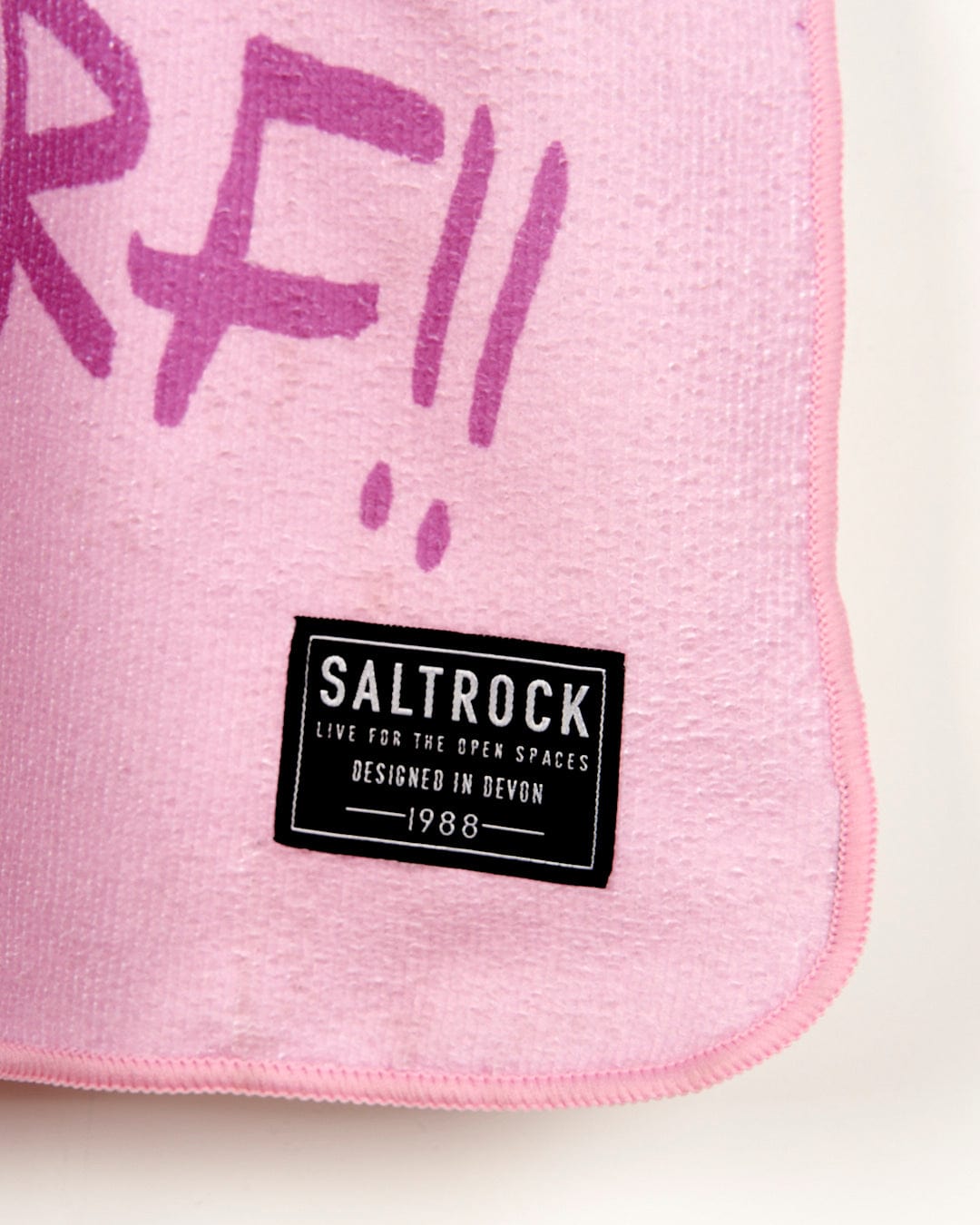 A Tik - Kids Changing Towel - Pink with the word Saltrock written on it.