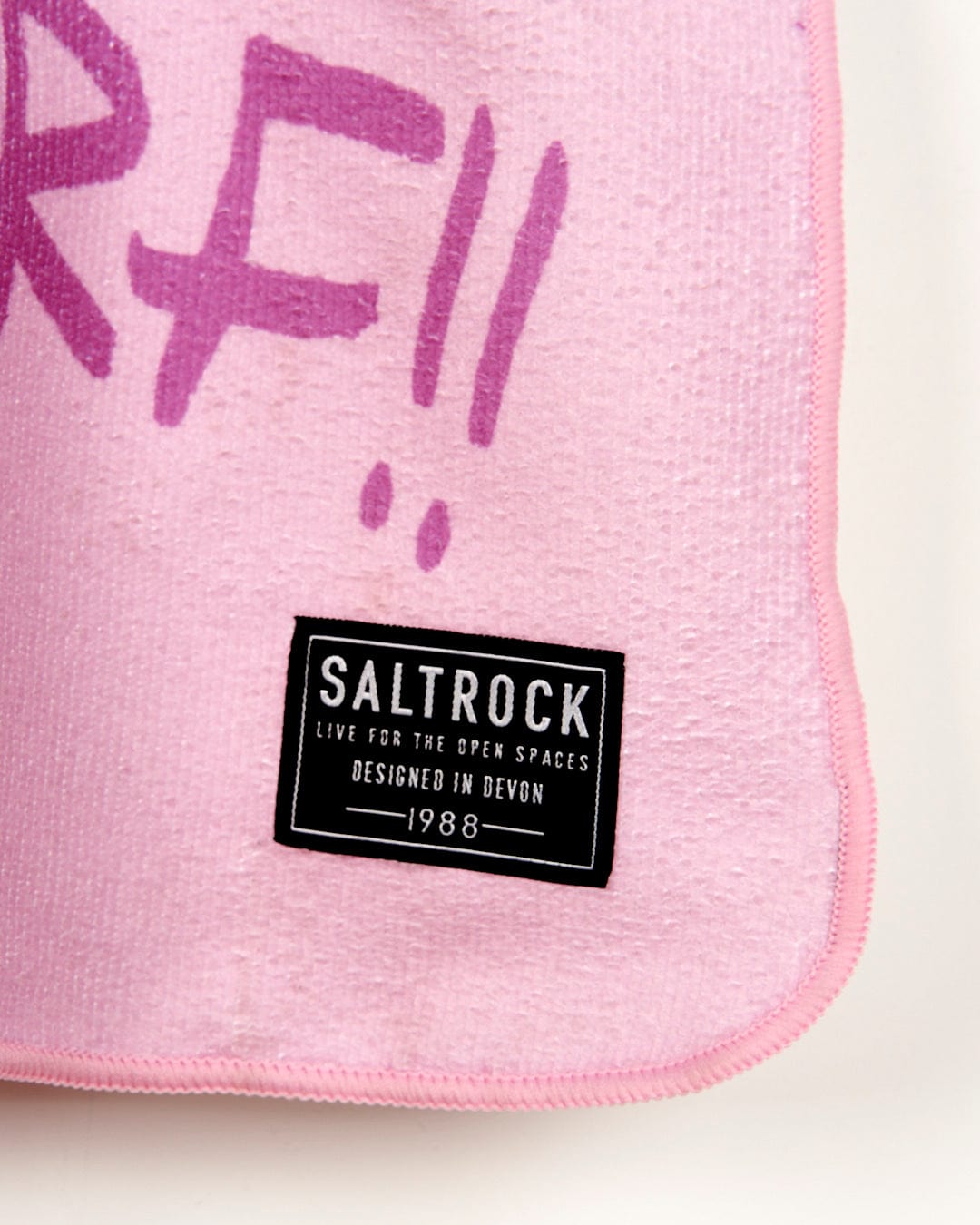 A Tik - Kids Changing Towel - Pink with the word Saltrock written on it.