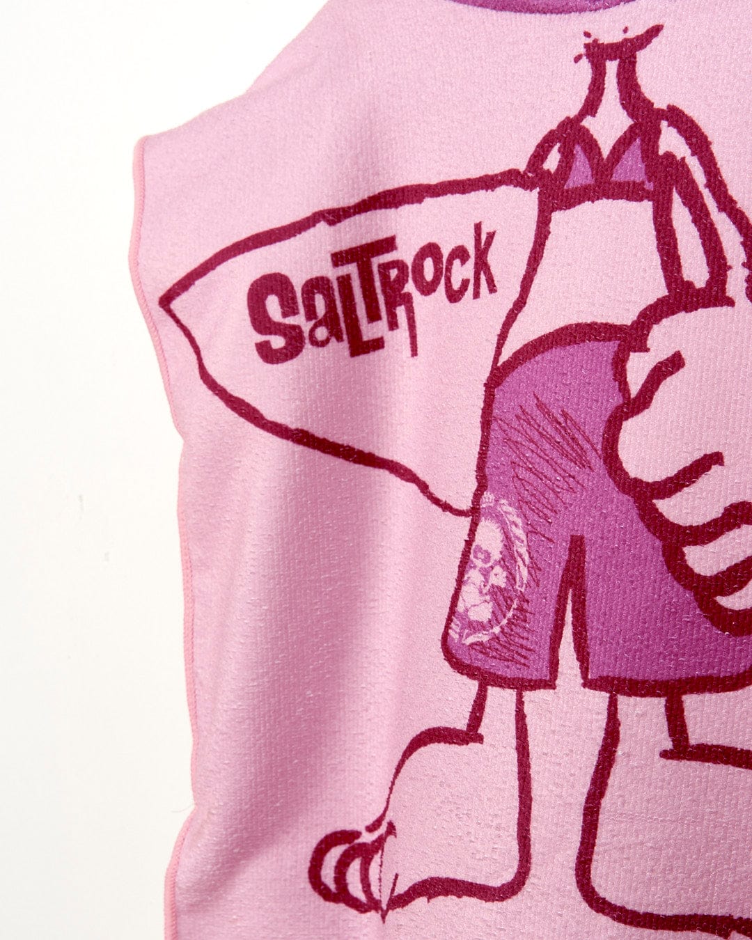 A Saltrock pink Tik - Kids Changing Towel - Pink with a cartoon character holding a surfboard.