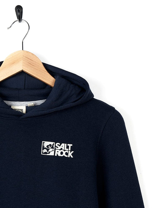 Dark blue Tok Corp - Recycled Kids Pop Hoodie hanging on a wooden hanger against a white background, displaying Saltrock branding on the left chest area.