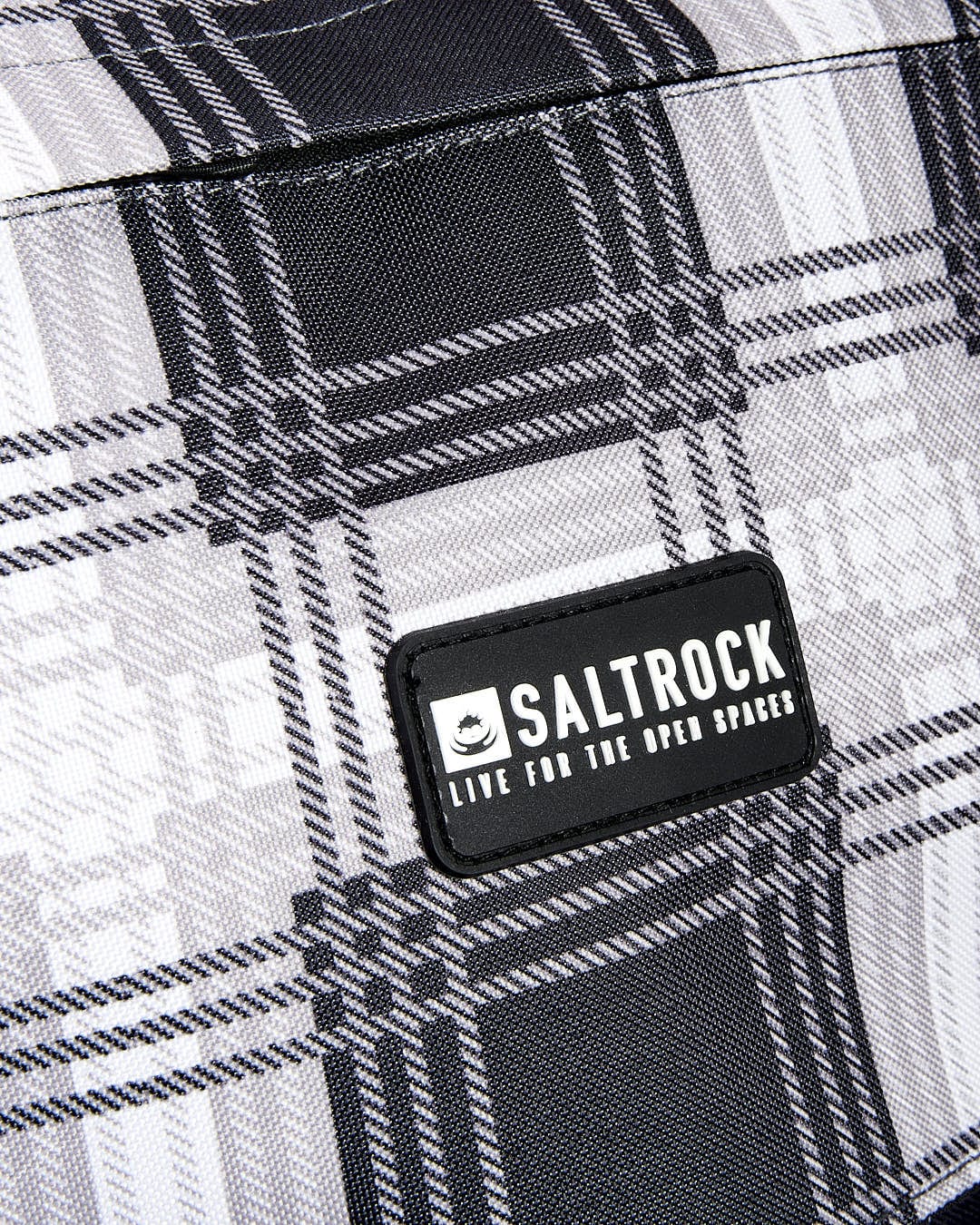 A black and white plaid bag with the Saltrock Top Loader - Backpack - Grey on it.