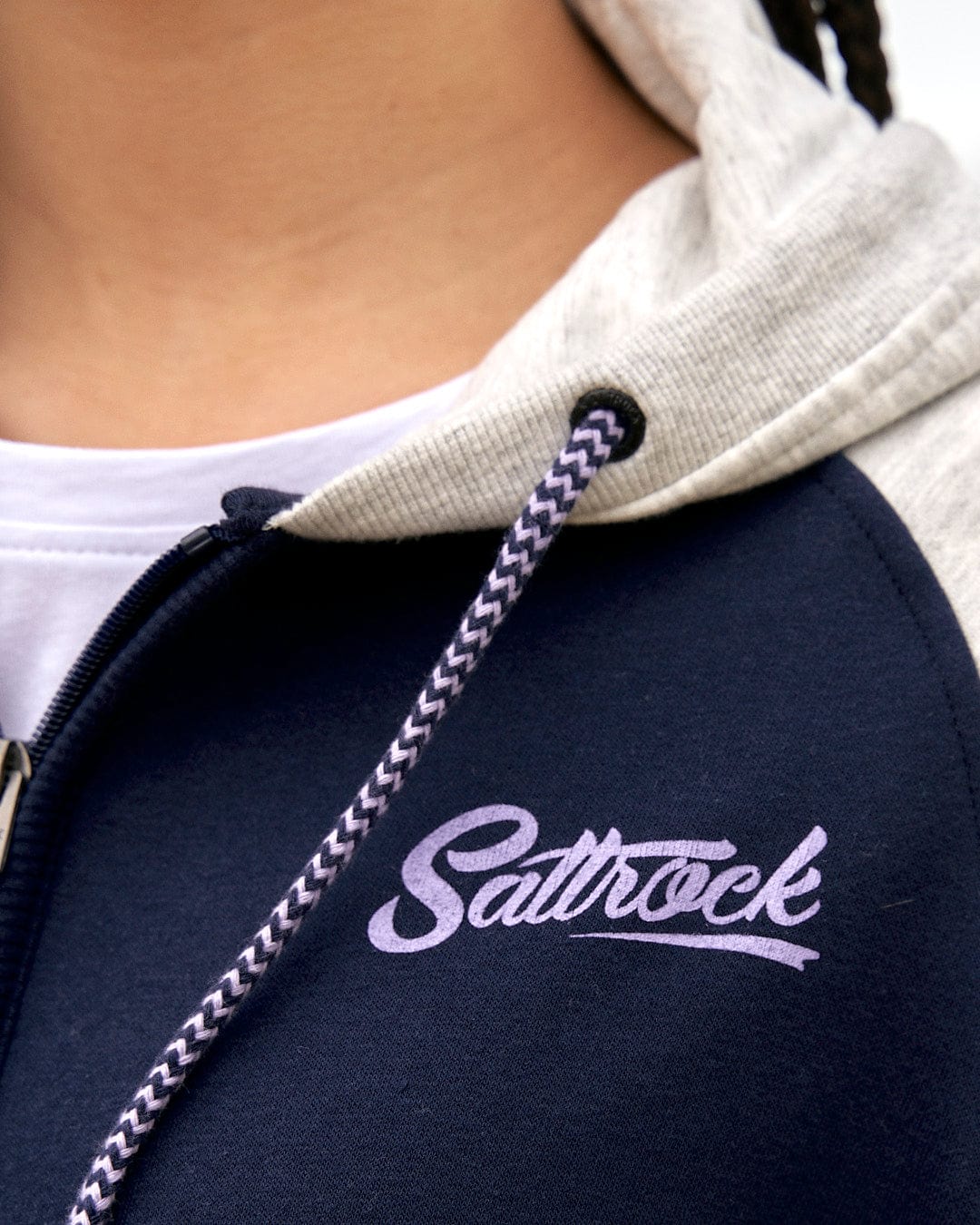 A woman wearing a Saltrock Zip Hoodie - Dark Blue.