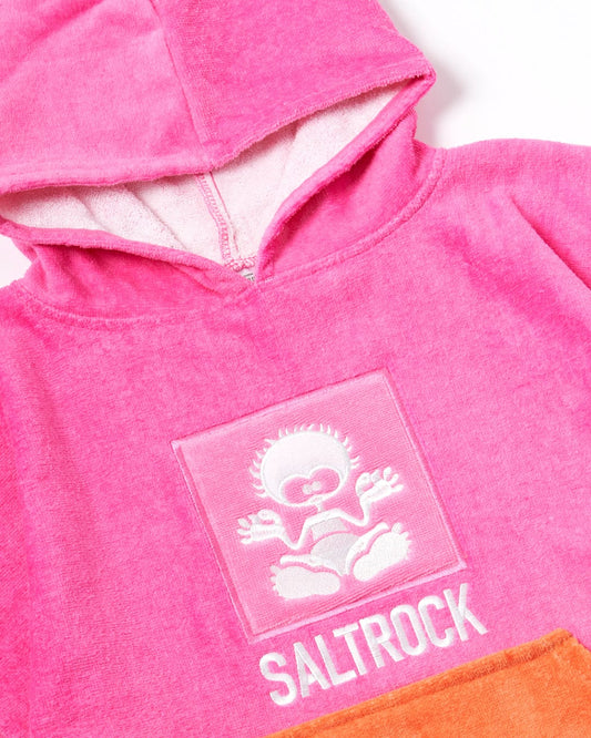 Close-up of a Saltrock pink Tropic Dip hoodie with a logo featuring a stylized sun and waves on the front, made from 100% cotton towelling.