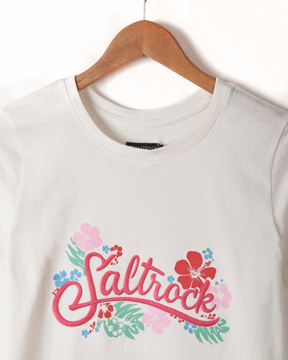 A Tropic - Womens T-Shirt - White with the branding "Saltrock" embroidered on it.