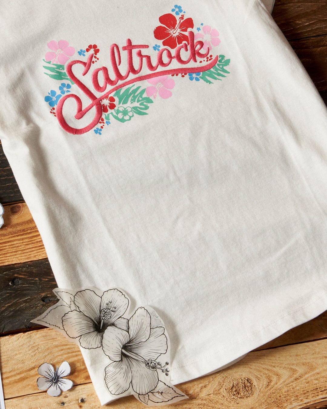 A Tropic - Womens T-shirt - White with the Saltrock branding embroidered on it.