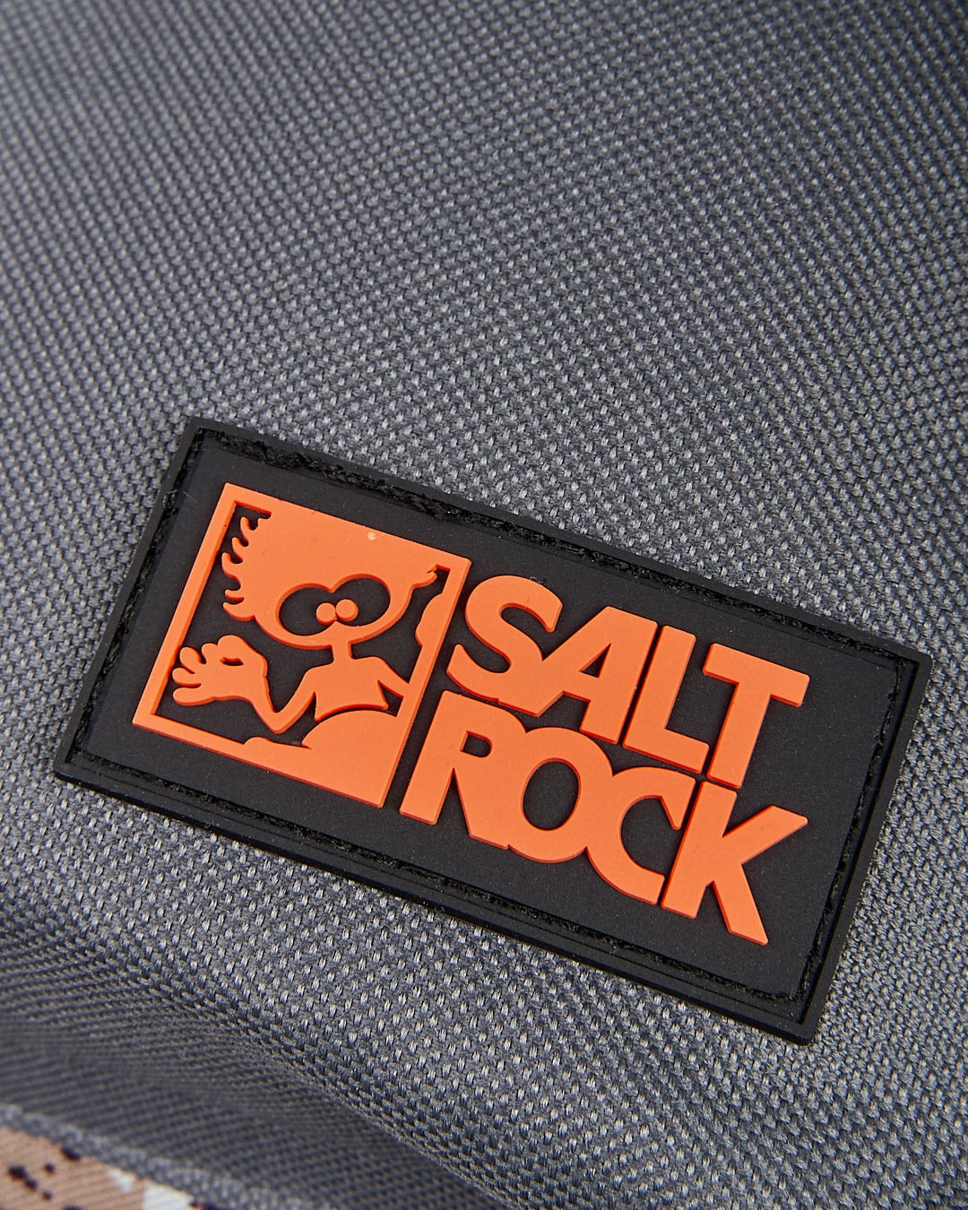 A close up of a Uni-Camo backpack with the Saltrock logo on it.