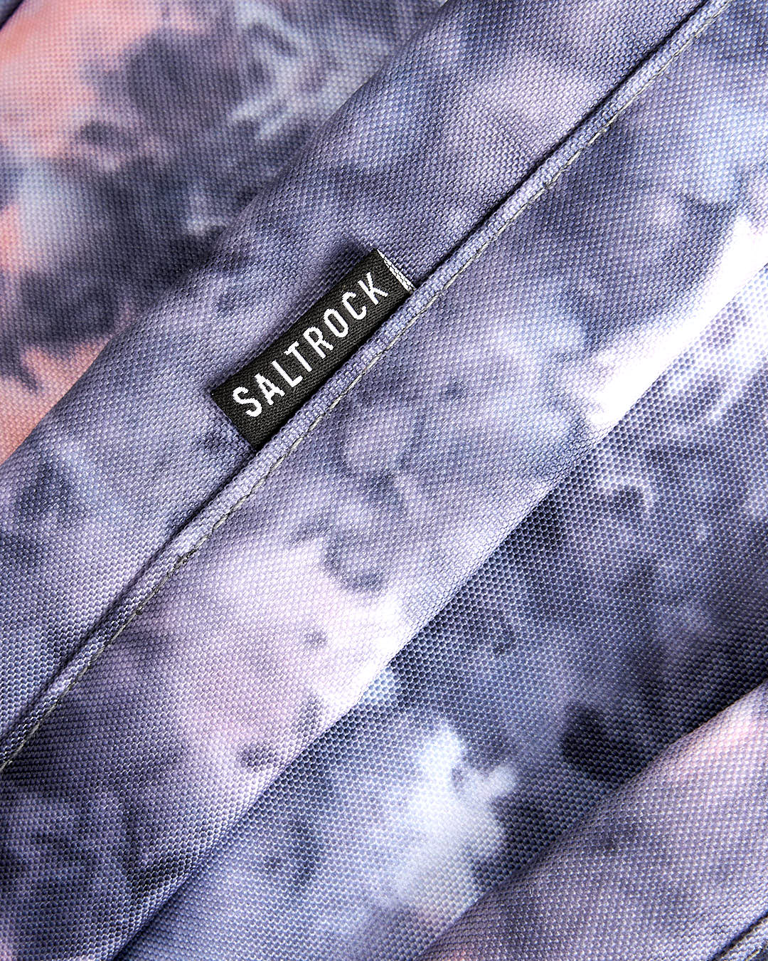 A close up of a Saltrock Uni-Vision - Backpack - Pink with a tie dye pattern.