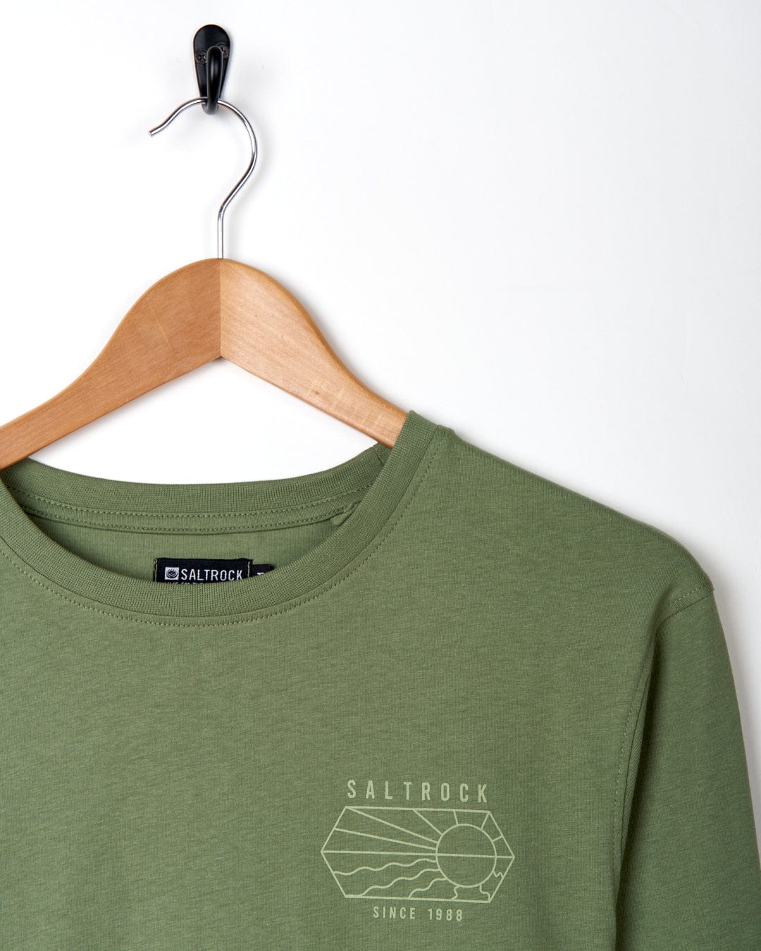 A green long-sleeved Saltrock Vantage Outline t-shirt with a logo on it.