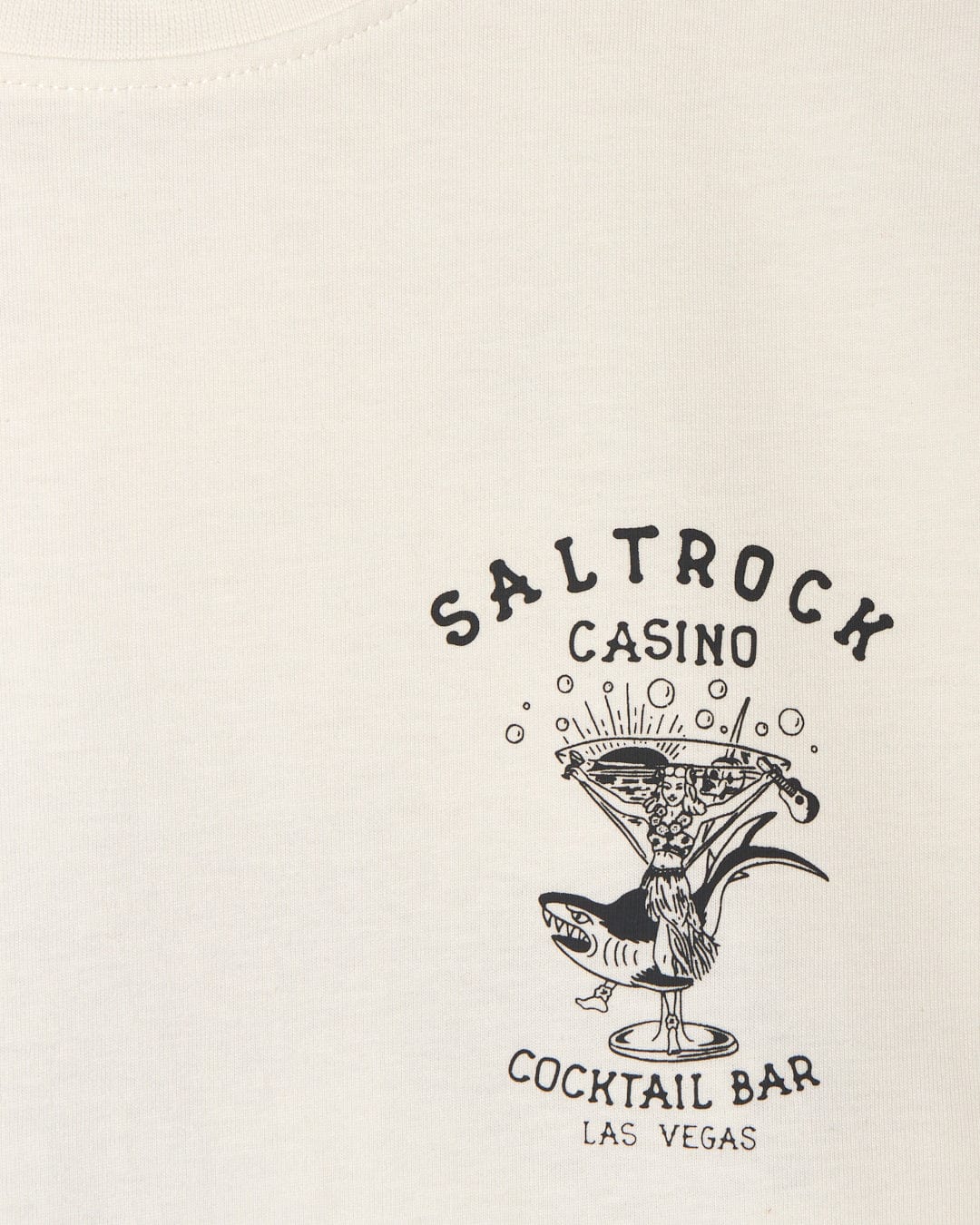 Graphic print of "Vegas Cocktail casino cocktail bar Las Vegas" on a beige fabric background with Saltrock branding and a crew neckline.