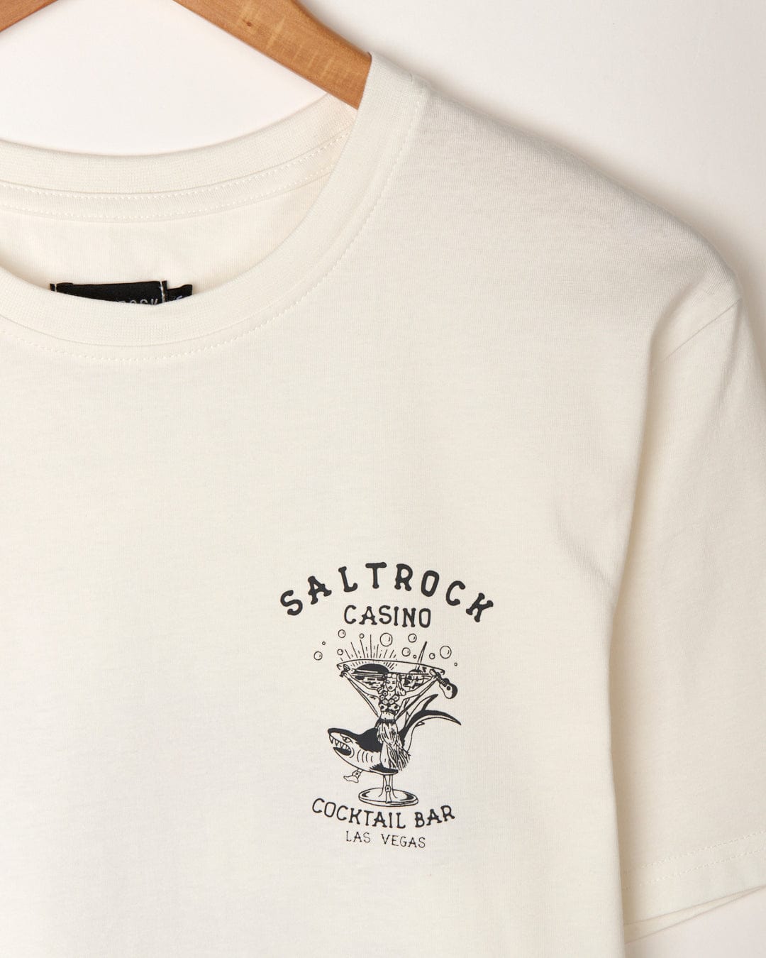 Close-up of a white Vegas Cocktail - Mens Short Sleeve T-Shirt with the Saltrock logo printed on the front, featuring a peached soft hand feel finish.
