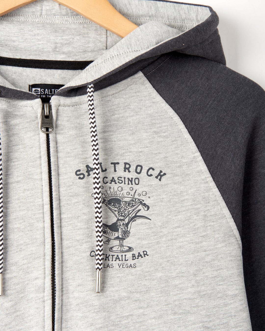 Gray zip-up hoodie with Saltrock Vegas Cocktail graphic print, displayed on a hanger. This marl effect fabric hoodie features raglan style sleeves for a comfortable fit.