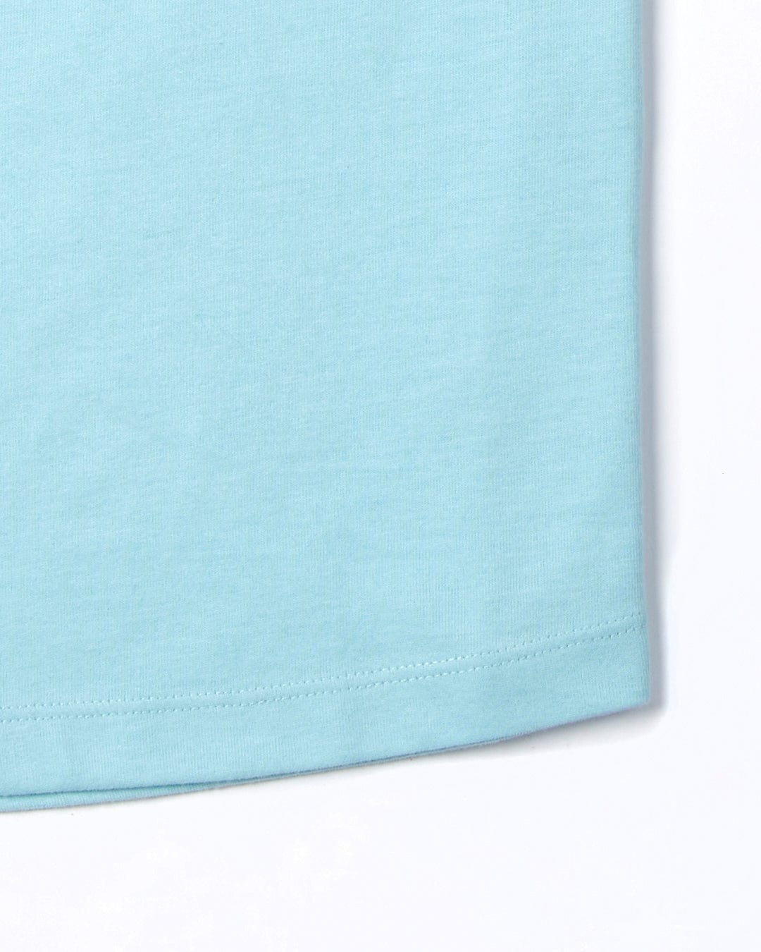 Close-up of a Velator - Womens Short Sleeve T-Shirt - Light Blue fabric texture with a visible hem stitch and Saltrock branding on a white background.