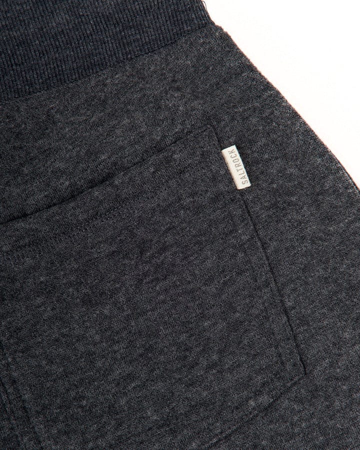 Close-up of a dark gray fabric texture with a visible Saltrock Velator Womens Joggers branding tag.