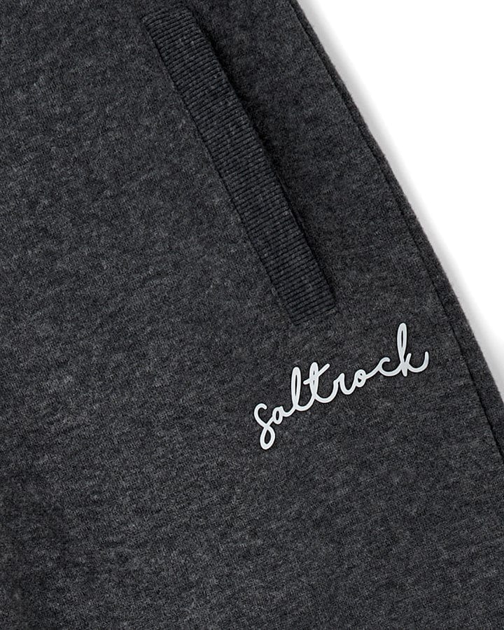 Close-up of a dark grey Velator joggers with a "Saltrock" logo and elasticated waist.