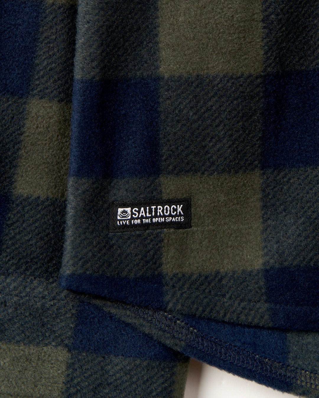 Close-up view of a Waldron - Mens Fleece Shirt - Dark Green with a Saltrock label attached.