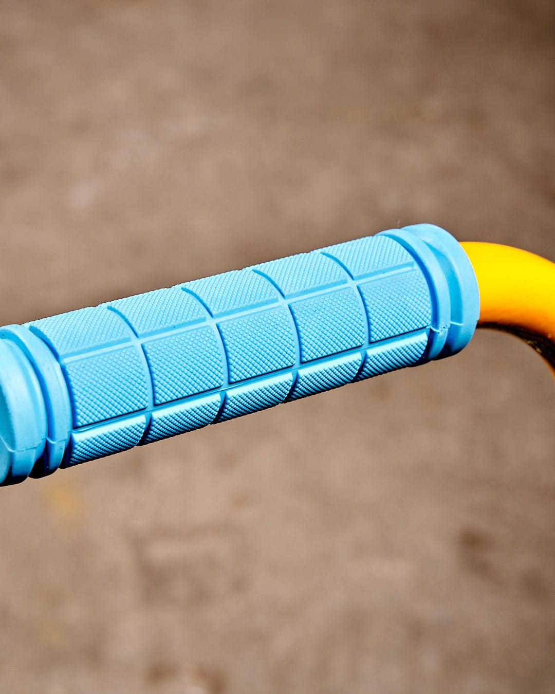 A close up of a Saltrock Warped - Stunt Scooter - Blue handle on a bicycle.