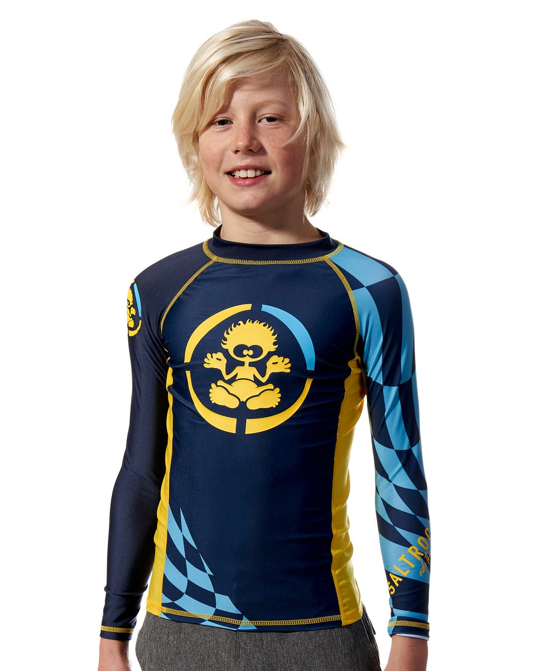 A young boy wearing a Saltrock Warp - Kids Long Sleeve Rash Vest - Blue.