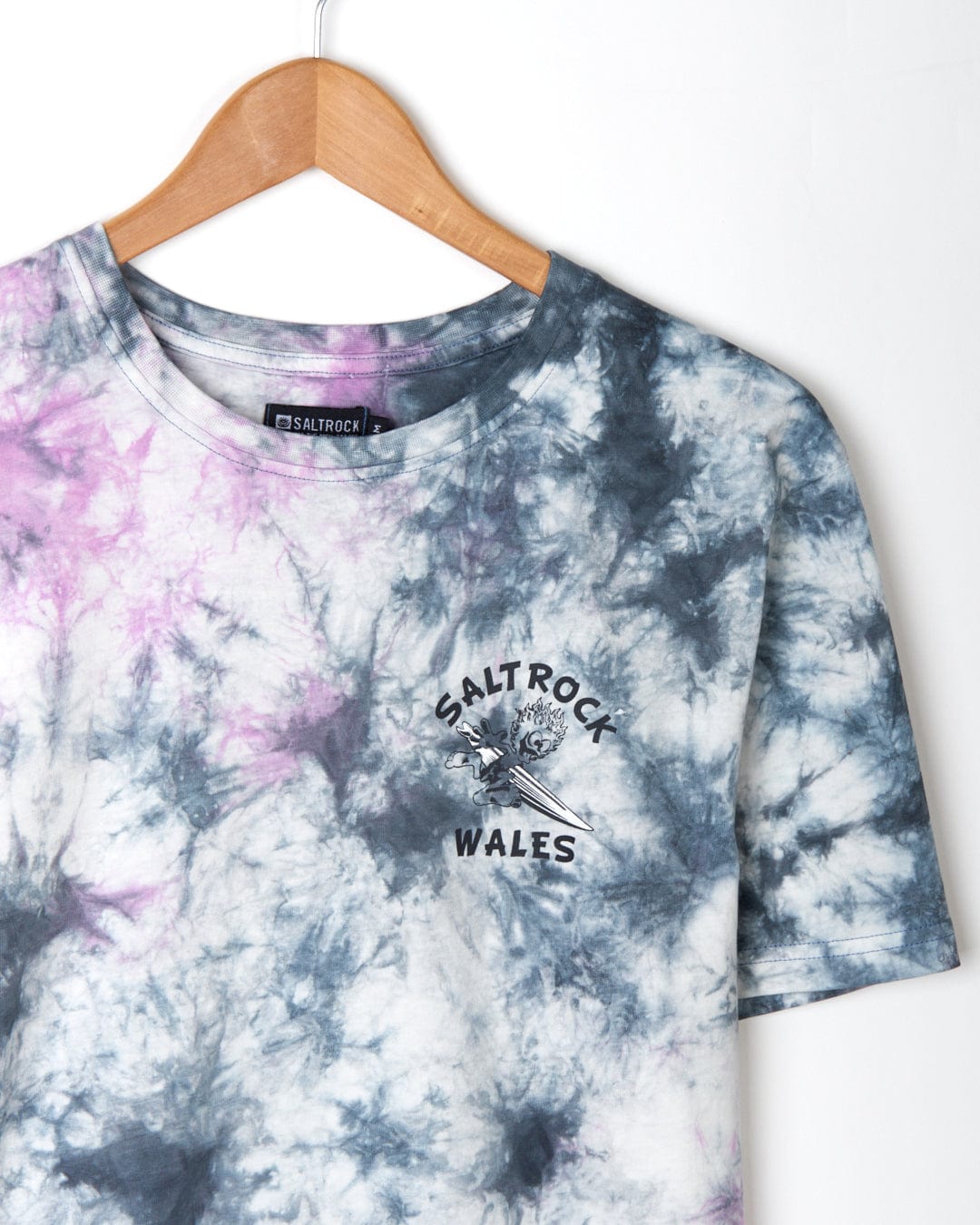 Wave Rider Wales - Mens Short Sleeve T-Shirt - Pink Tie Dye with Saltrock branding hanging on a wooden hanger against a white background.