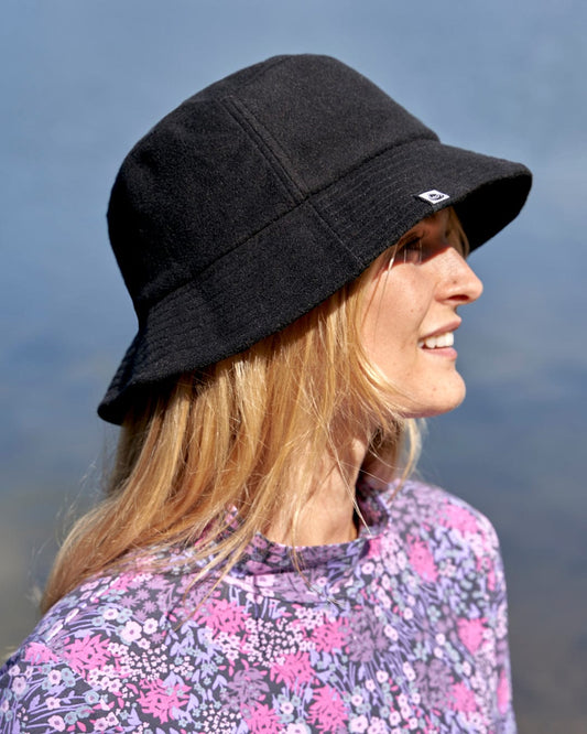Stay cool and stylish with a woman sporting the Saltrock Wavey - Reversible Bucket Hat - Black.