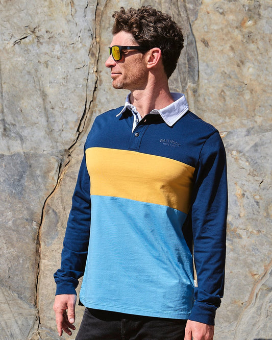 A man wearing sunglasses and a Saltrock Wesley - Mens Panelled Rugby Shirt - Blue polo shirt.