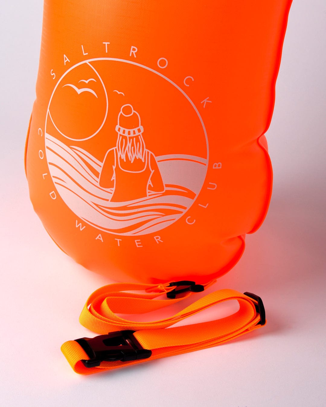 Bright orange waterproof Wild dry bag with Saltrock logo on white background, perfect for cold water swimming.