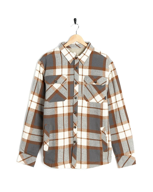 A stylish Woody - Mens Sherpa Lined Shacket in brown and white, hanging on a hanger by Saltrock.