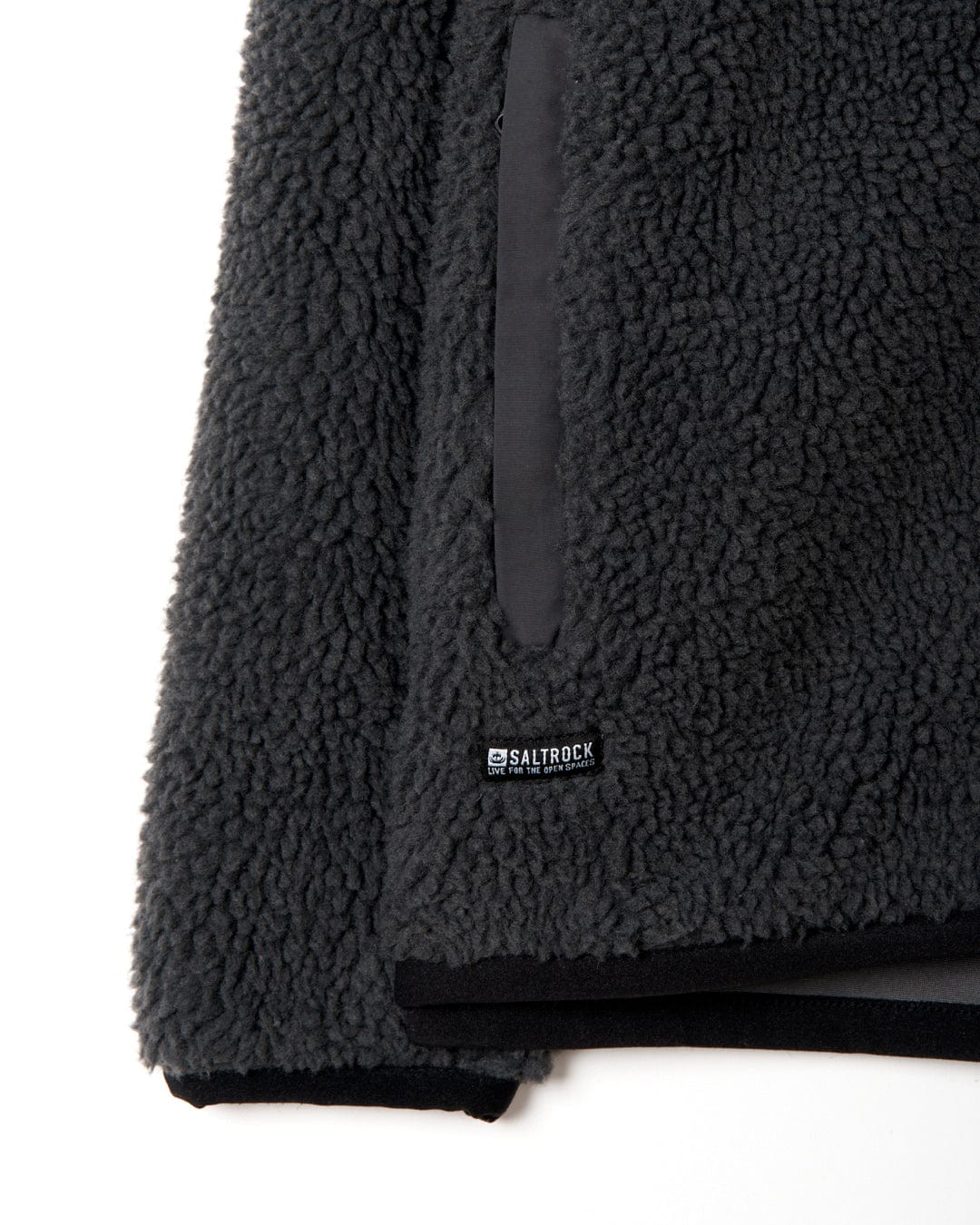 A close up of a black Wye - Mens Zip Sherpa Fleece - Dark Grey jacket with Saltrock branding.