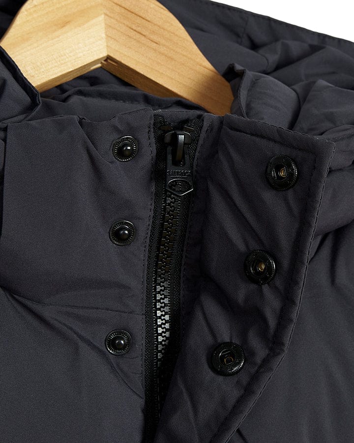 A Xavier - Mens Padded Gilet - Dark Grey, made by Saltrock and is water-resistant, is displayed on a wooden hanger.