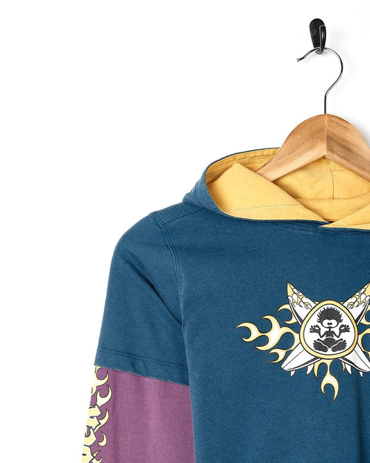 A Saltrock X Boards - Kids Hooded Tee - Blue/Purple with a skull and crossbones on it.