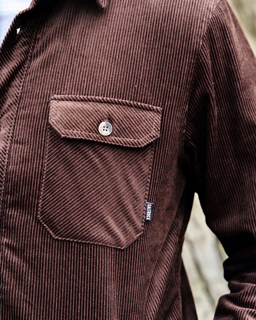 A man displaying his fashion style in a comfortable Zeke - Mens Cord Borg Lined Shacket - Dark Brown shirt by Saltrock.