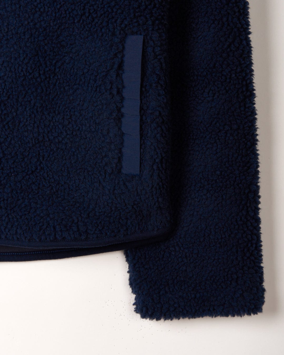 A cozy Zella - Womens 1/4 Neck Fleece - Dark Blue material in a close up of a Saltrock towel.