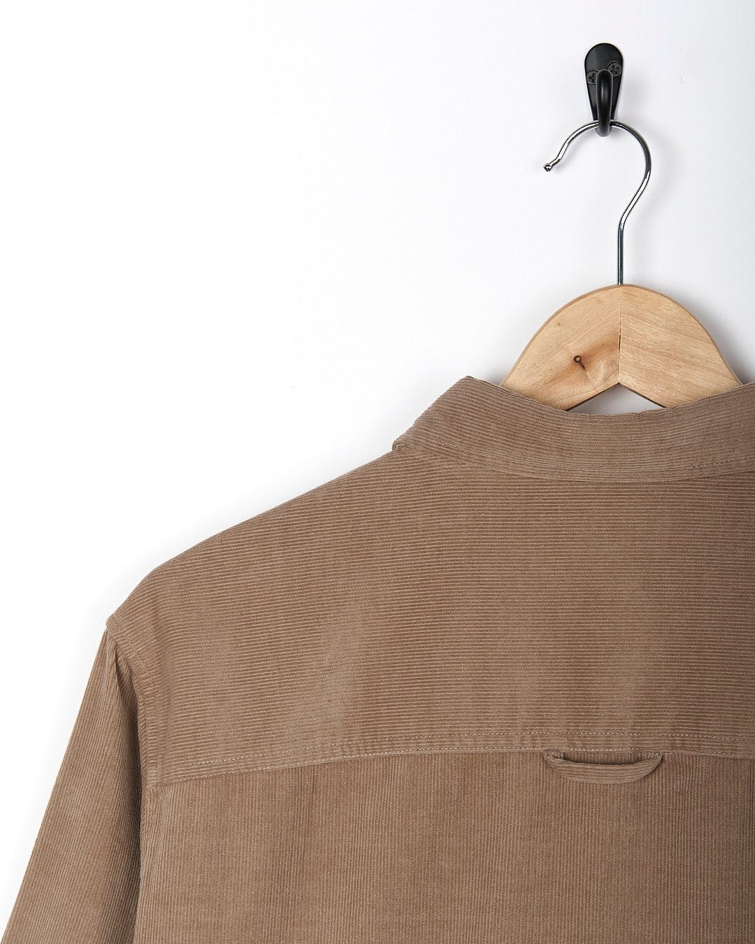 A Saltrock - Ace Men Corduroy Shirt - Light Brown hanging on a wooden hanger.